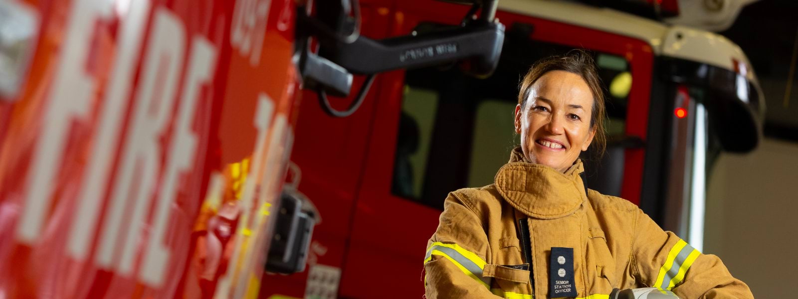 A firefighter in front of a truck 