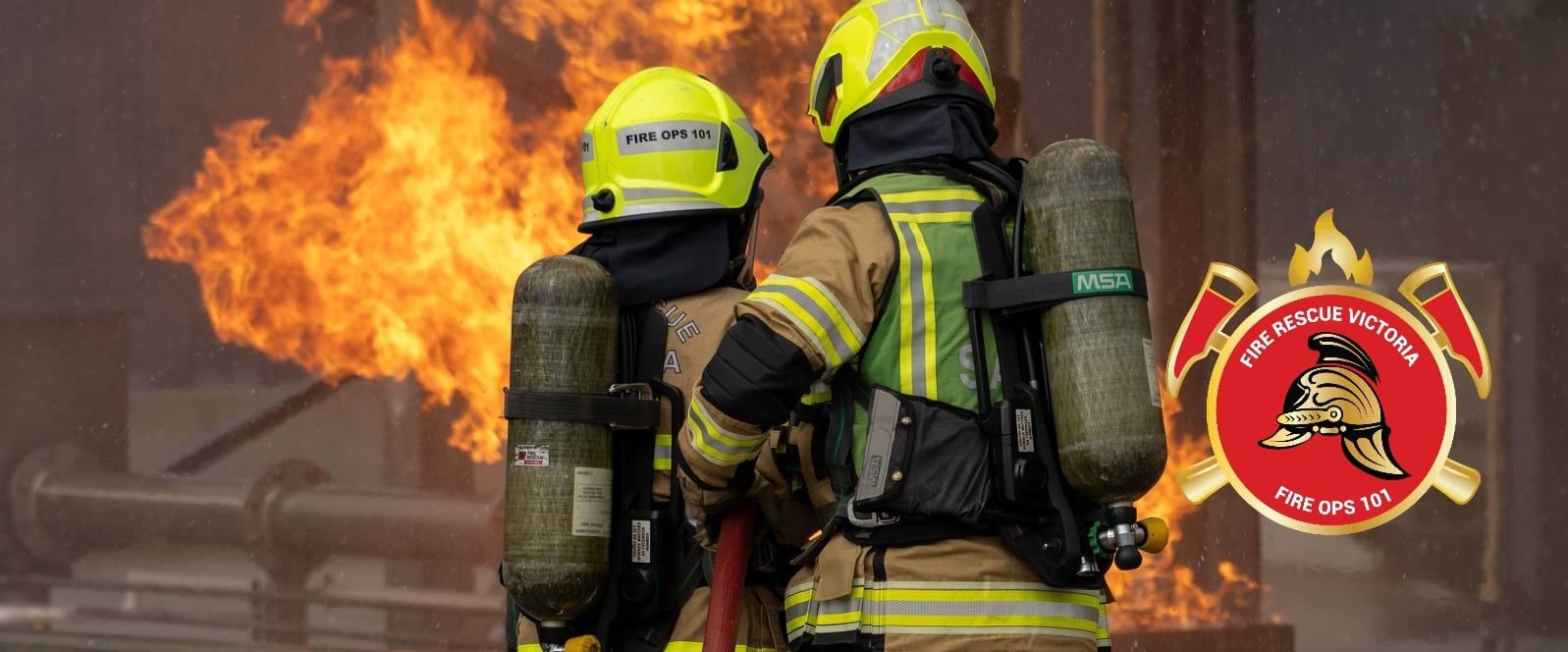 Participants putting out a fire in the Fire Ops 101 course 